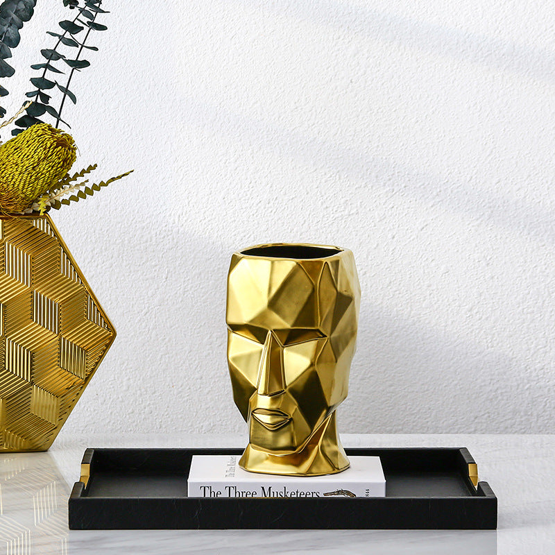 Vase visage abstrait doré